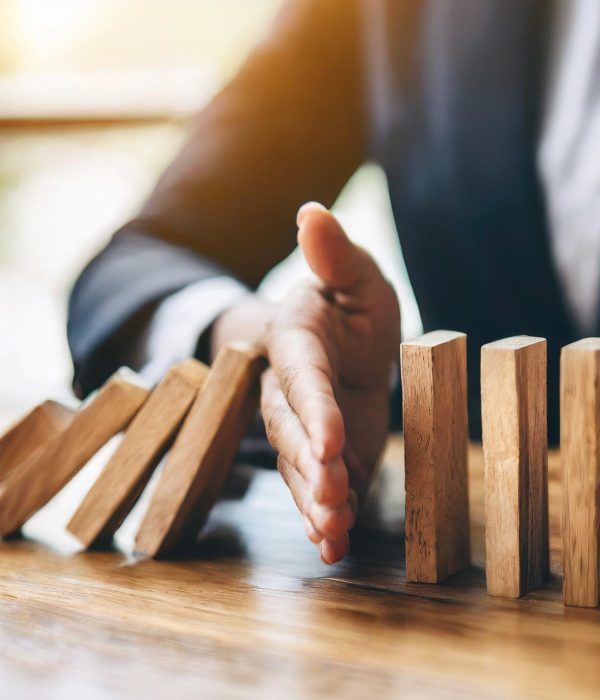 business-hand-halts-wooden-dominoes-from-falling-symbolizing-prevention-business-cris